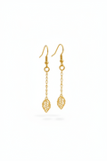 Gold leaf-shaped earrings on a white background