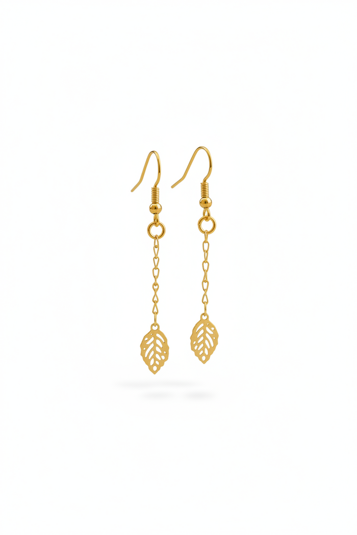 Gold leaf-shaped earrings on a white background