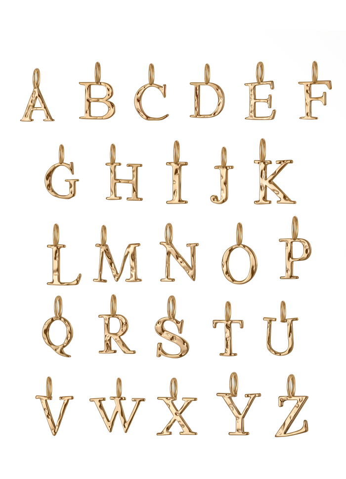 The Alphabet Charm Necklace by LLUME Jewelry features 26 gold uppercase letter charms with loops for attaching to a chain—ideal for creating customizable, personalized jewelry.