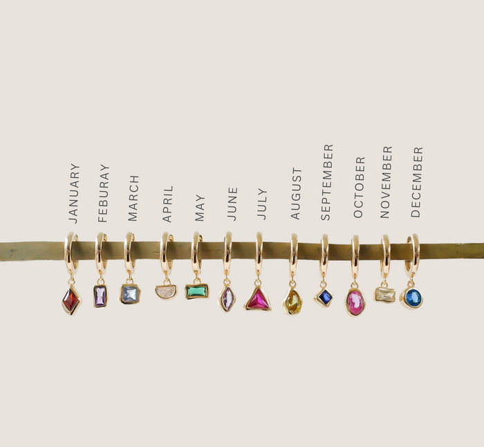 LLUME Jewelry’s Birthstone Earrings feature twelve gold-plated earrings, each with a unique gemstone charm representing every month from January to December for a personalized touch.