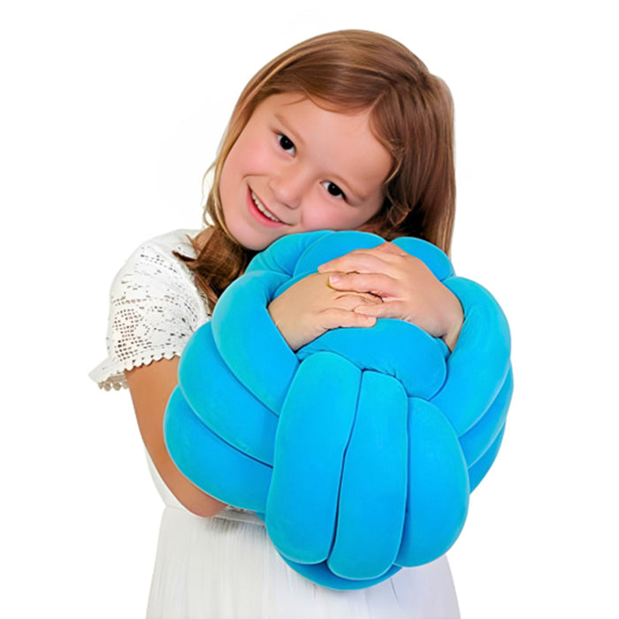 Child holding a blue pillow against a white background