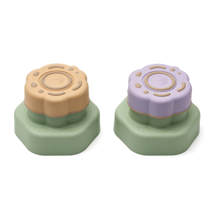 Two colorful plastic stepping stones with floral designs on a white background