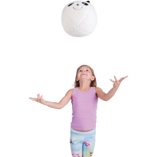 Girl playing with a panda-shaped ball on a white background