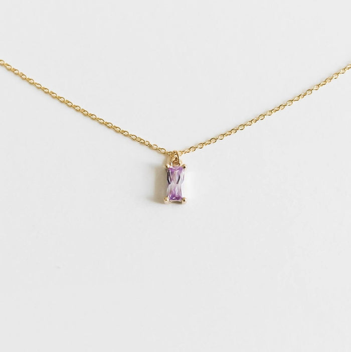 The Celia Necklace by LLUME Jewelry is a delicate gold vermeil piece featuring a small rectangular lilac gemstone pendant, elegantly showcased on a plain white background.