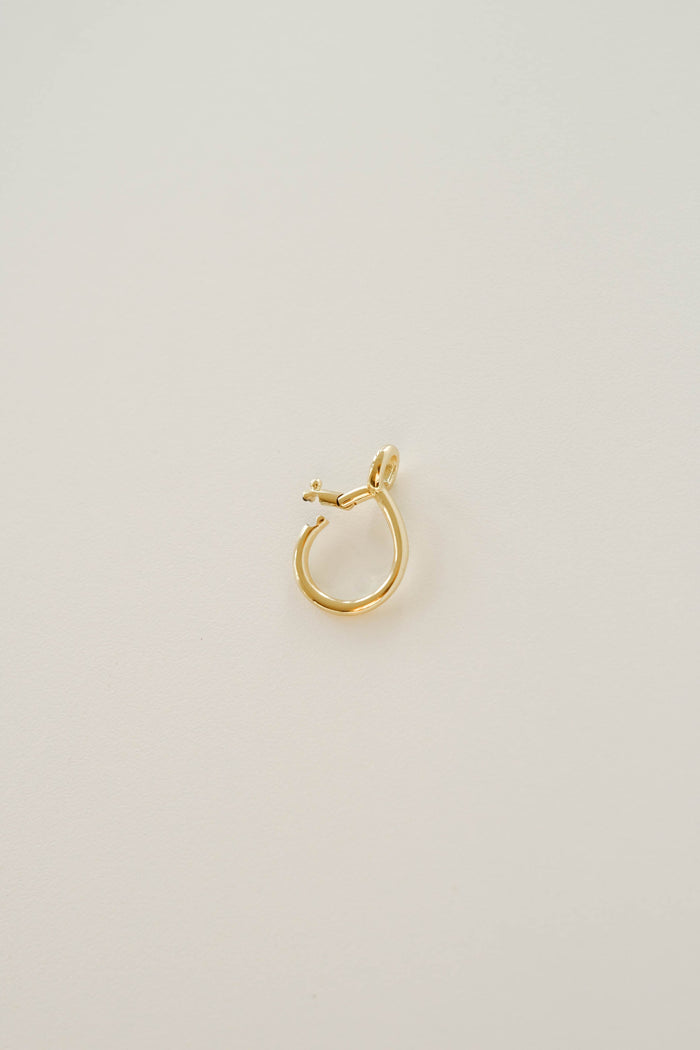 A single small LLUME Jewelry Charm Holder earring, 18K gold filled with a stud closure, is shown on a plain, light-colored background.