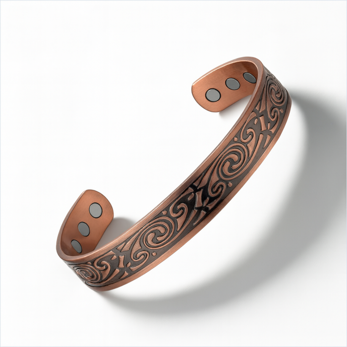 Engraved copper magnetic cuff bracelet with adjustable open back design and magnetic inserts on a white background