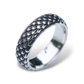 A stainless steel ring with a detailed, textured dragon scale design.