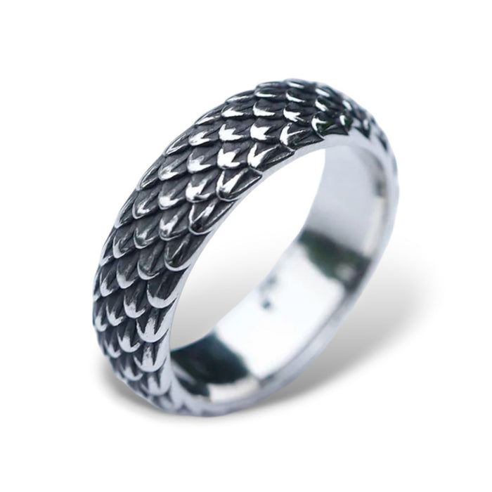 A stainless steel ring with a detailed, textured dragon scale design.