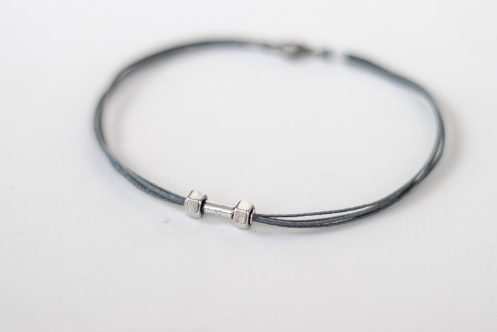 gray cord anklet with a silver-tone dumbbell charm