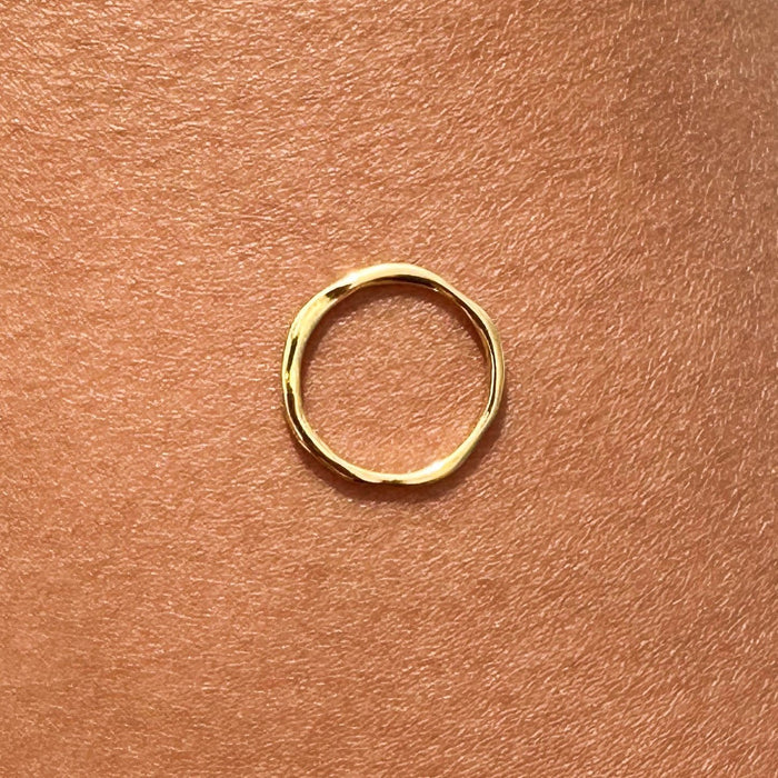 The Dune Ring by LLUME Jewelry is a simple, uneven 14k gold-filled band—ideal for daily wear or stacking with your favorite rings.
