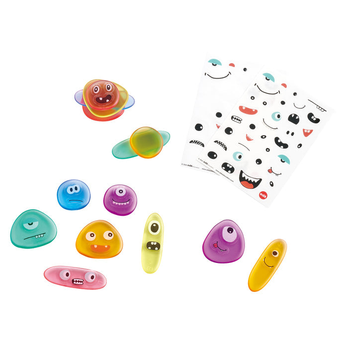 Colorful stones with face stickers on a white background
