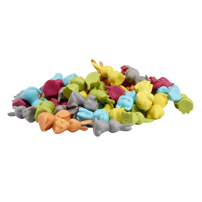 Colorful assortment of small animal-shaped toys on a white background
