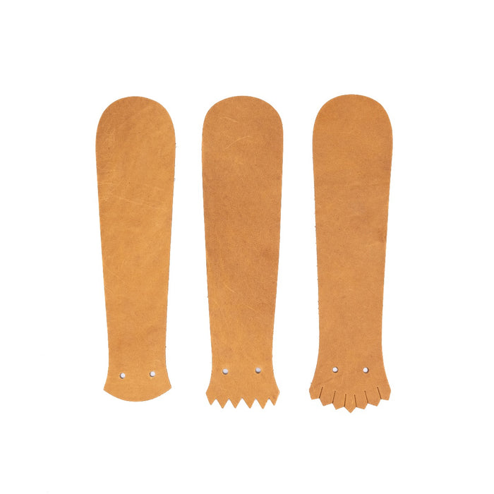 Tan leather Kilties on a white background.