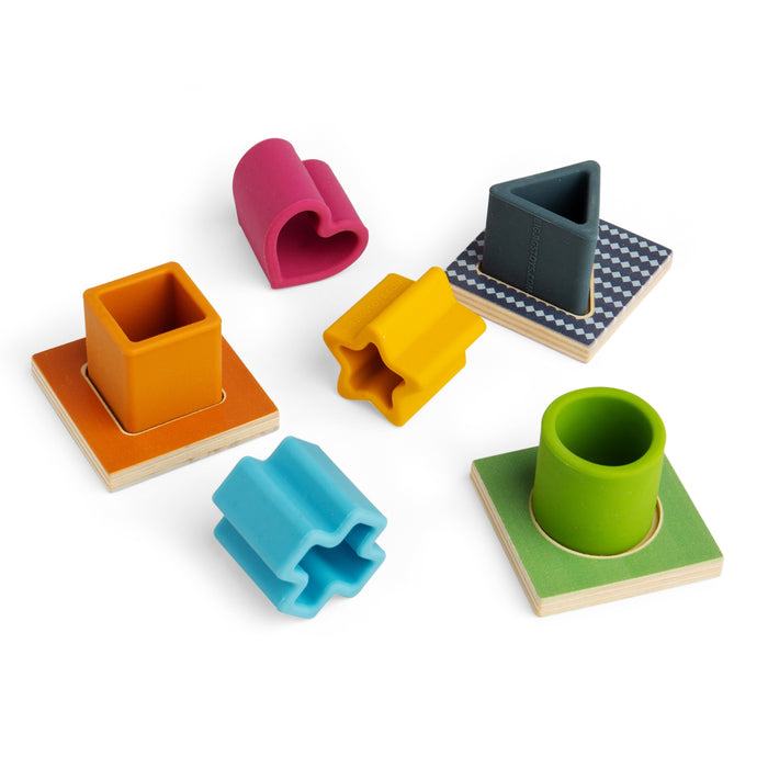Set of colorful geometric shape sorting toys on a white background