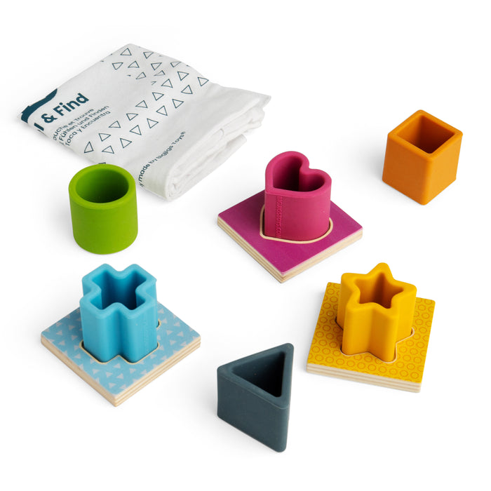 Colorful geometric shape sorting toys with a paper guide on a white background