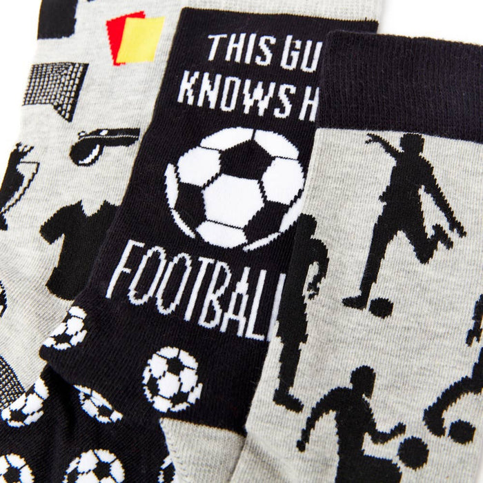 close up of football themed socks showing ball and player patterns
