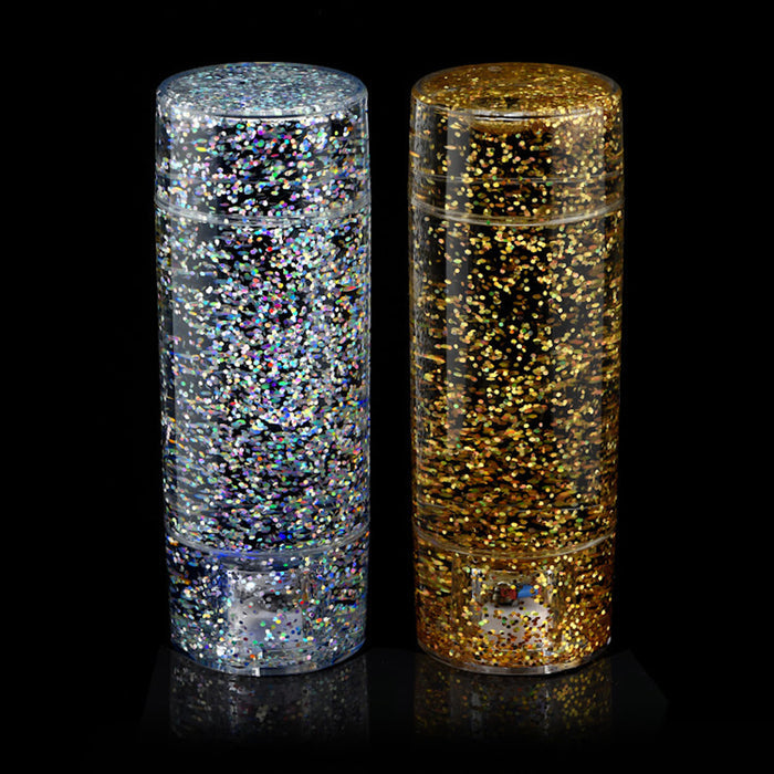 Two cylindrical containers filled with glitter, one silver and one gold, on a black background.