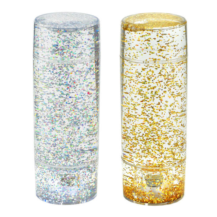 Two cylindrical containers filled with glitter, one silver and one gold, on a white background.