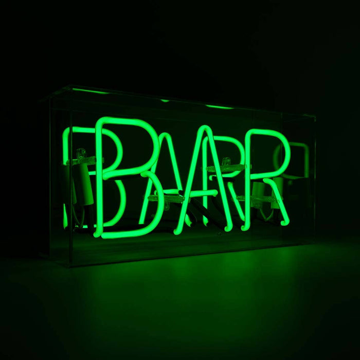 Green Bar glass neon sign glowing inside a clear acrylic display box against a dark background