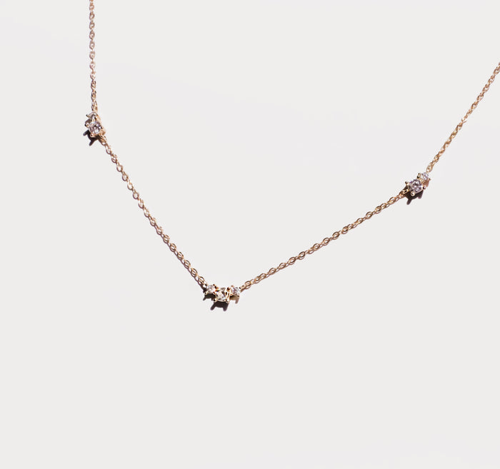 The Juliet Necklace by LLUME Jewelry is a gold-plated chain with three evenly spaced round crystal pendants in subtle prong settings, shown on a white background—an ideal pick for lovers of elegant accessories.
