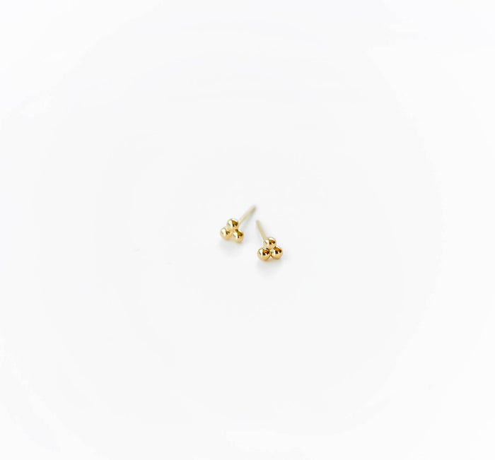 The June Studs by LLUME Jewelry, minimalist earrings crafted from gold plated sterling silver, are displayed side by side on a white background with their posts facing outward.