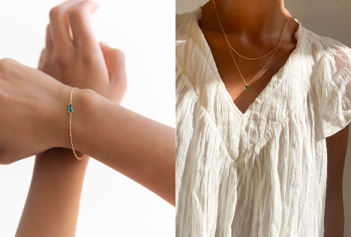 Side-by-side image: Left, a gold bracelet with green gemstone from the LLUME Jewelry Kismet Starter Set. Right, stacked gold necklaces with matching green pendant over a white blouse—showcasing effortless layering with the Kismet Starter Set.