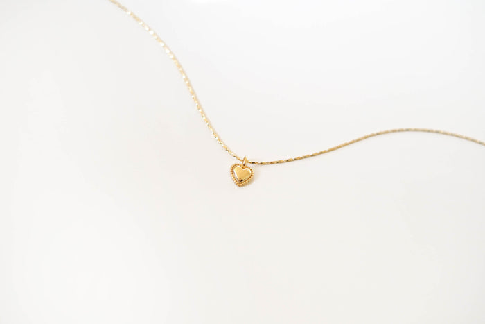 The LLUME Jewelry Love Heart Necklace, featuring a delicate gold-plated heart-shaped pendant, is showcased on a plain white background.
