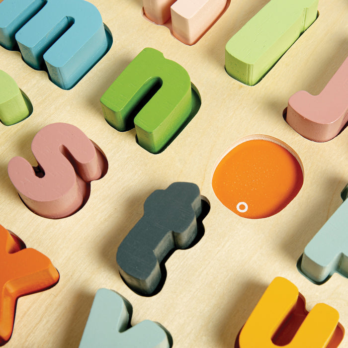 Colorful wooden letters on a beige surface