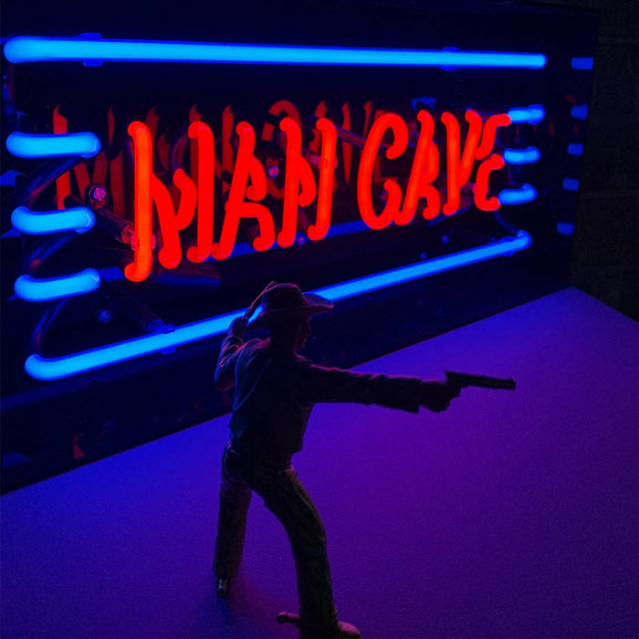 Man Cave glass neon sign displayed in a stylish entertainment room setting