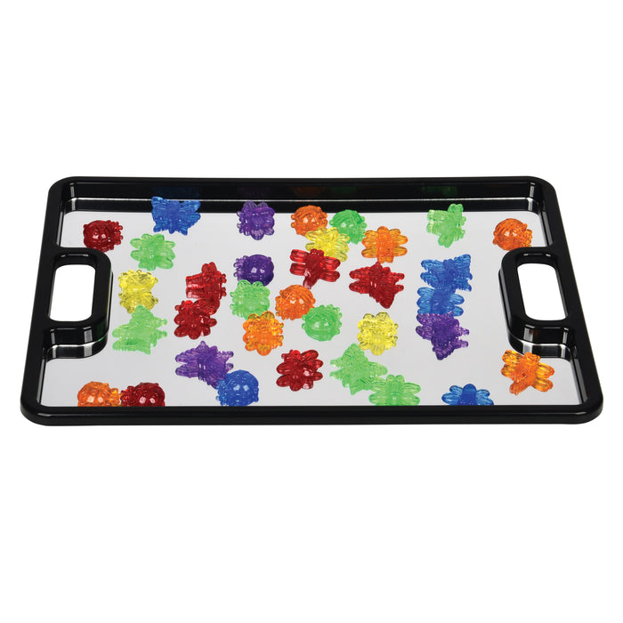 Colorful transparent figurines  on a black tray with mirrored surface
