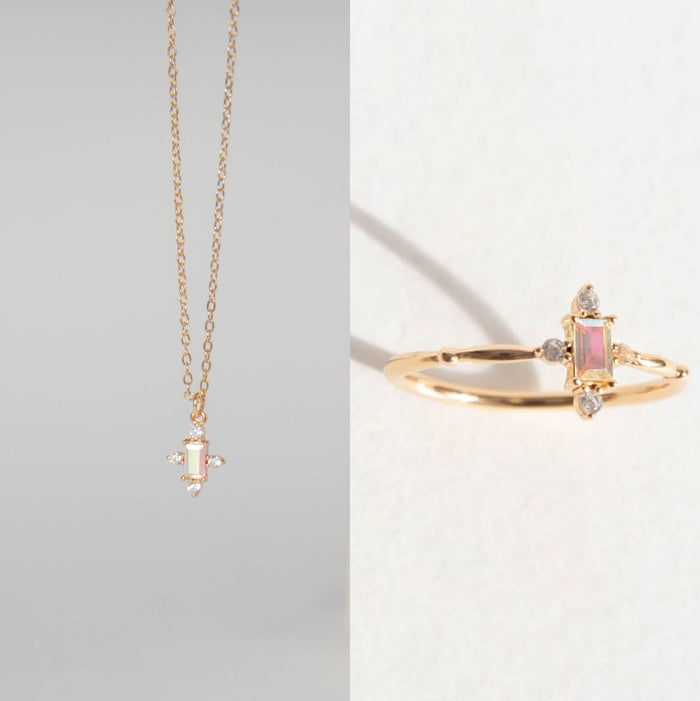 The LLUME Jewelry Moment Set features a gold necklace with a rectangular pink gemstone pendant and a matching stacking ring, displayed side by side on a neutral background.