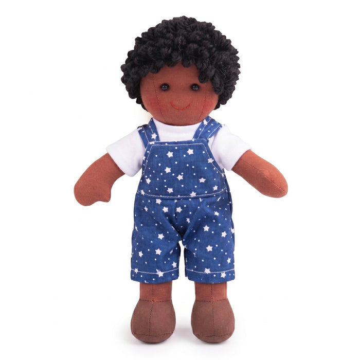 Doll wearing blue overalls with star pattern on a white background