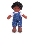 Doll wearing blue overalls with star pattern on a white background