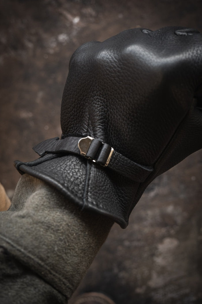 Nicks Fire Gloves in black on hand with adjustable wrist strap