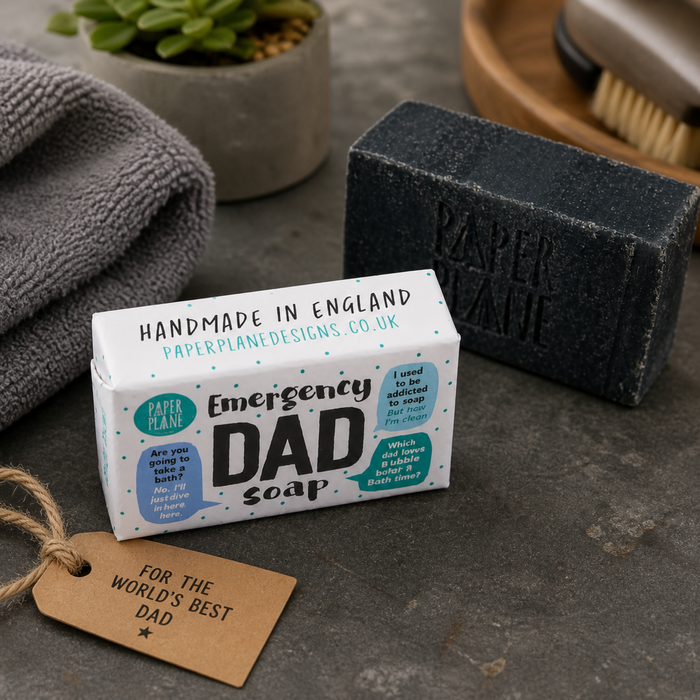 Paper Plane Emergency Dad Soap with charcoal soap bar and towel on dark stone surface