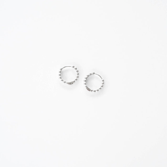 Two small LLUME Jewelry Prosecco Beaded Hoops Silver, adorned with evenly spaced beads, are displayed on a plain white background.