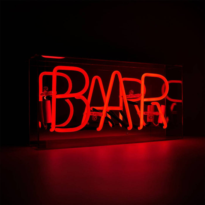 Red BAR neon sign glowing in low light from an angled view