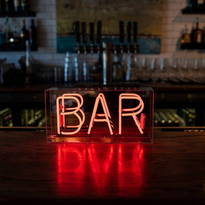 Red BAR neon sign displayed in a stylish home bar interior