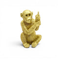 Mmall golden resin monkey with middle finger on white background