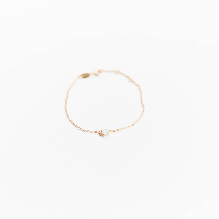The Sardinia Bracelet by LLUME Jewelry features a delicate gold plated sterling silver chain with a small white stone centerpiece, shown on a plain white background.