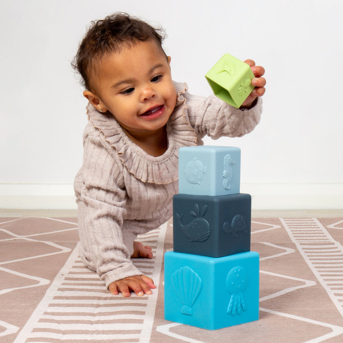Child playing with colorful blocks on a patterned rug