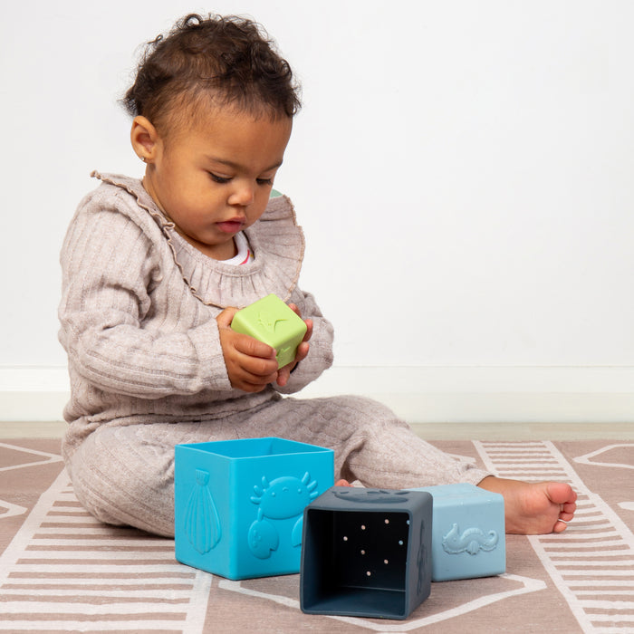 Child playing with colorful blocks on a patterned rug