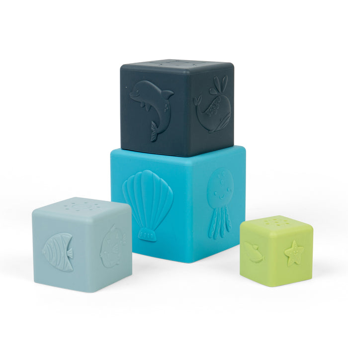Four colorful silicone blocks with embossed sea creature designs on a white background
