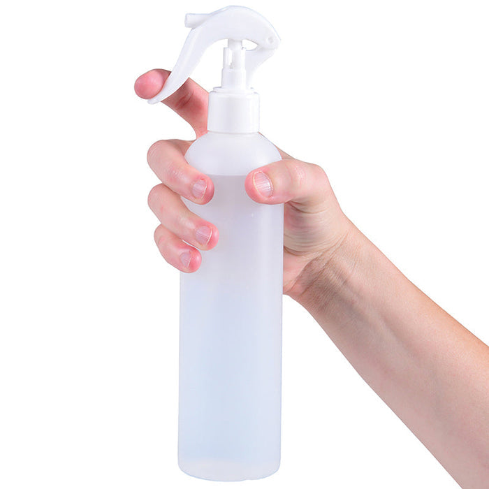 hand holding white spray bottle on white background