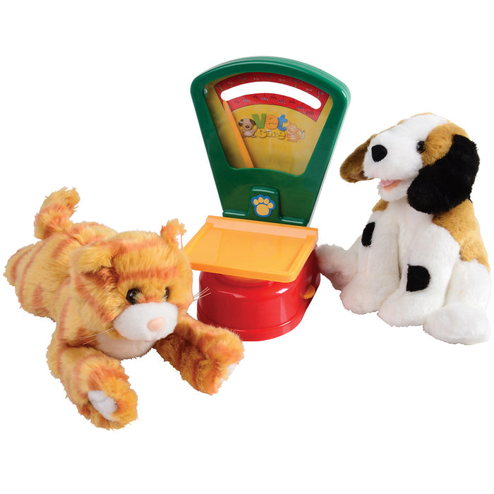 Stuffed cat and dog beside pretend play scale