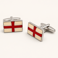 Pair of St George flag England cufflinks with red and cream enamel in a polished silver tone setting on an off white background.