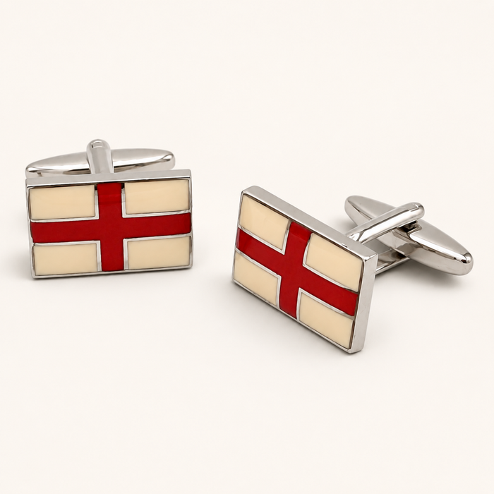 Pair of St George flag England cufflinks with red and cream enamel in a polished silver tone setting on an off white background.
