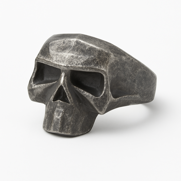 Stainless steel geometric skull ring with distressed matte finish on a white background.