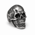 Front view of a stainless steel skull ring with a detailed vintage finish on a white background.