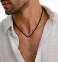 Man wearing a white shirt with a Star of David necklace.
